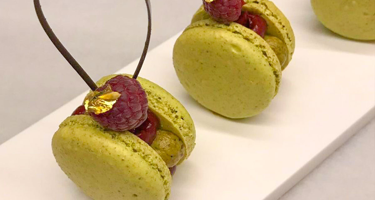 close up of a fancy cookie and raspberry