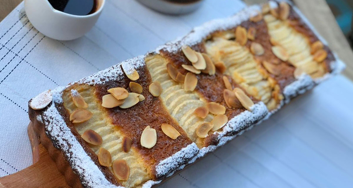 close up of a cake on a board with coffee